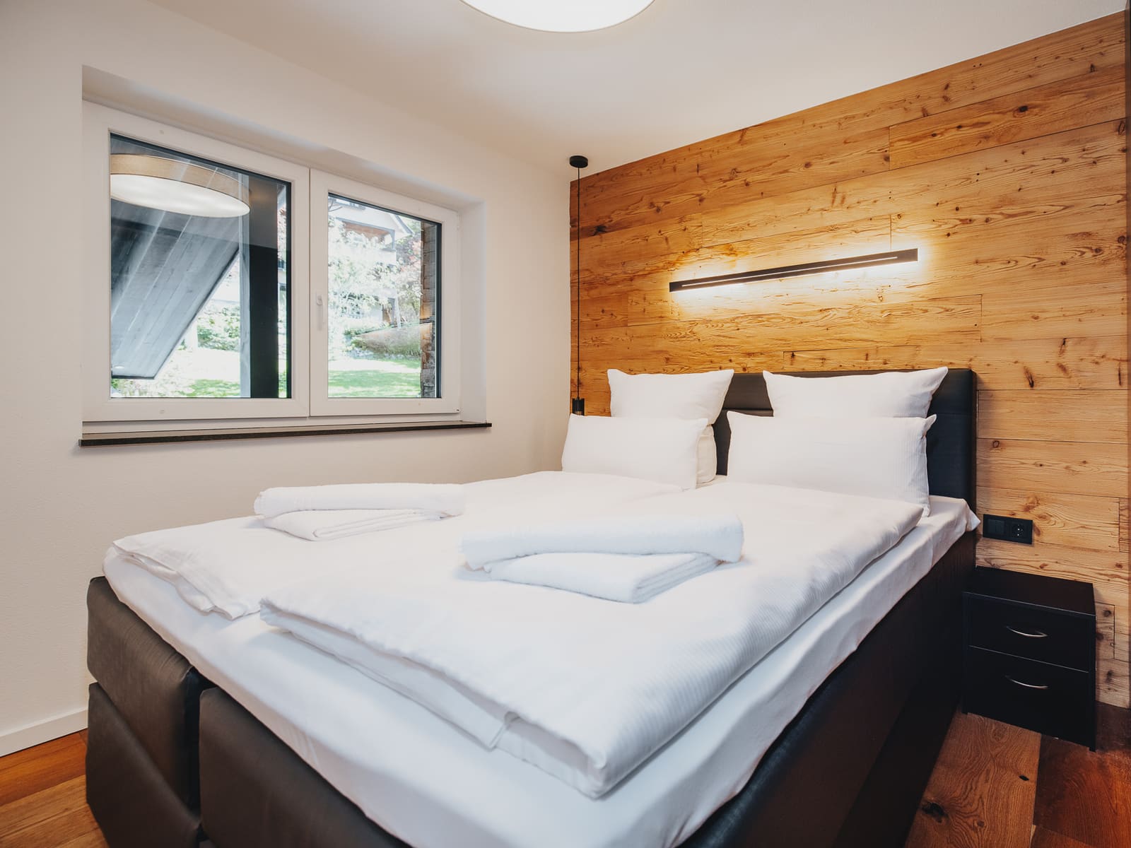 Schlafzimmer mit Holzwand